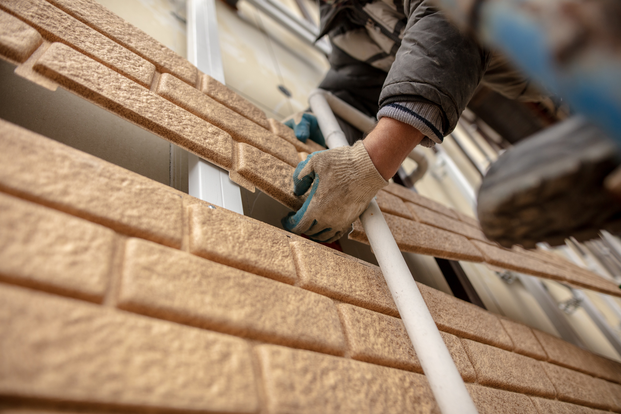 Installation of plastic siding under the brick